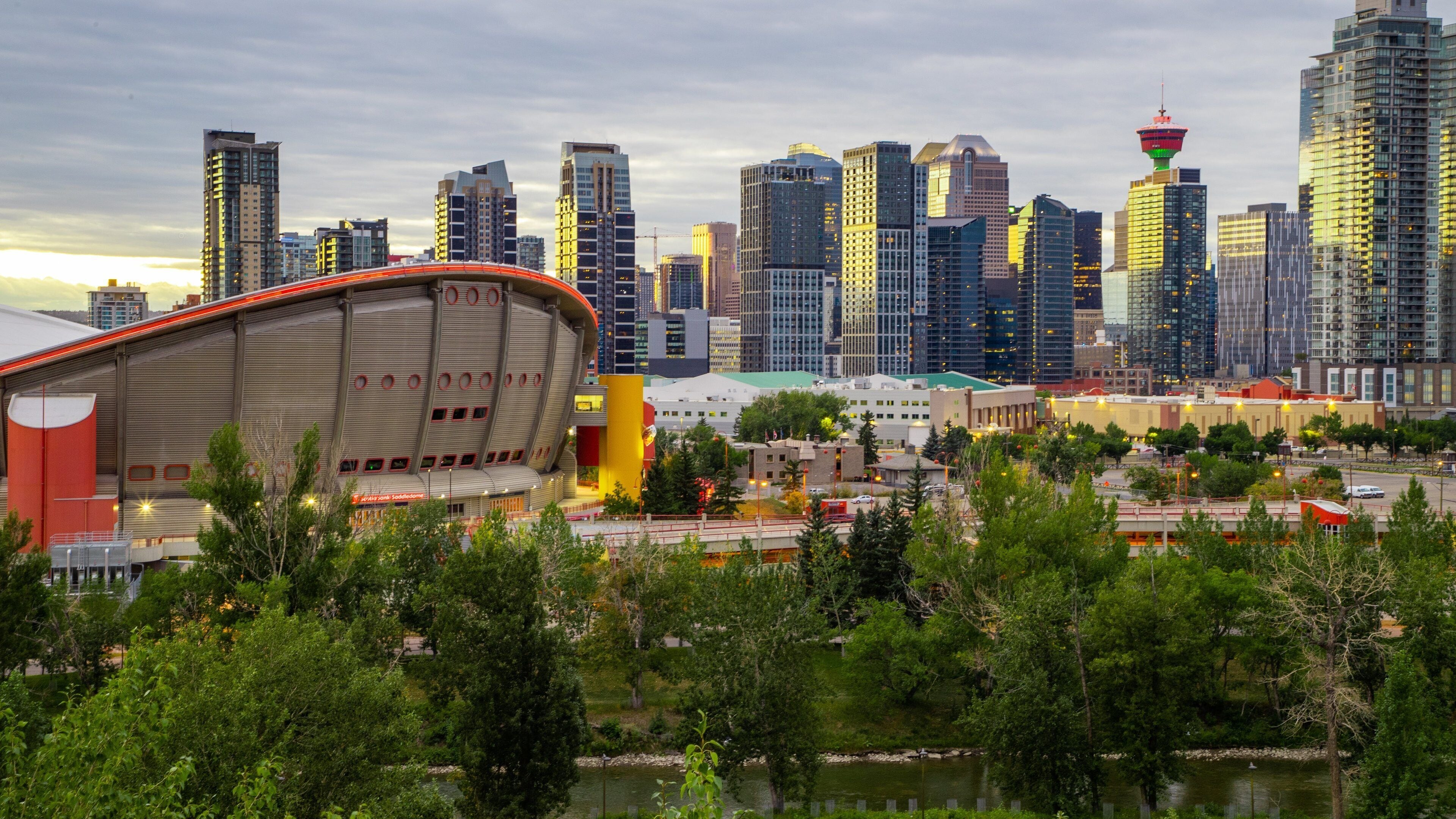 Scotiabank Saddledome featuring a city, a sunset and modern architecture