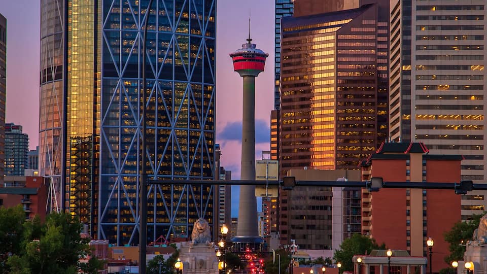 A cityscape with modern skyscrapers, a prominent tower, and a lion statue.