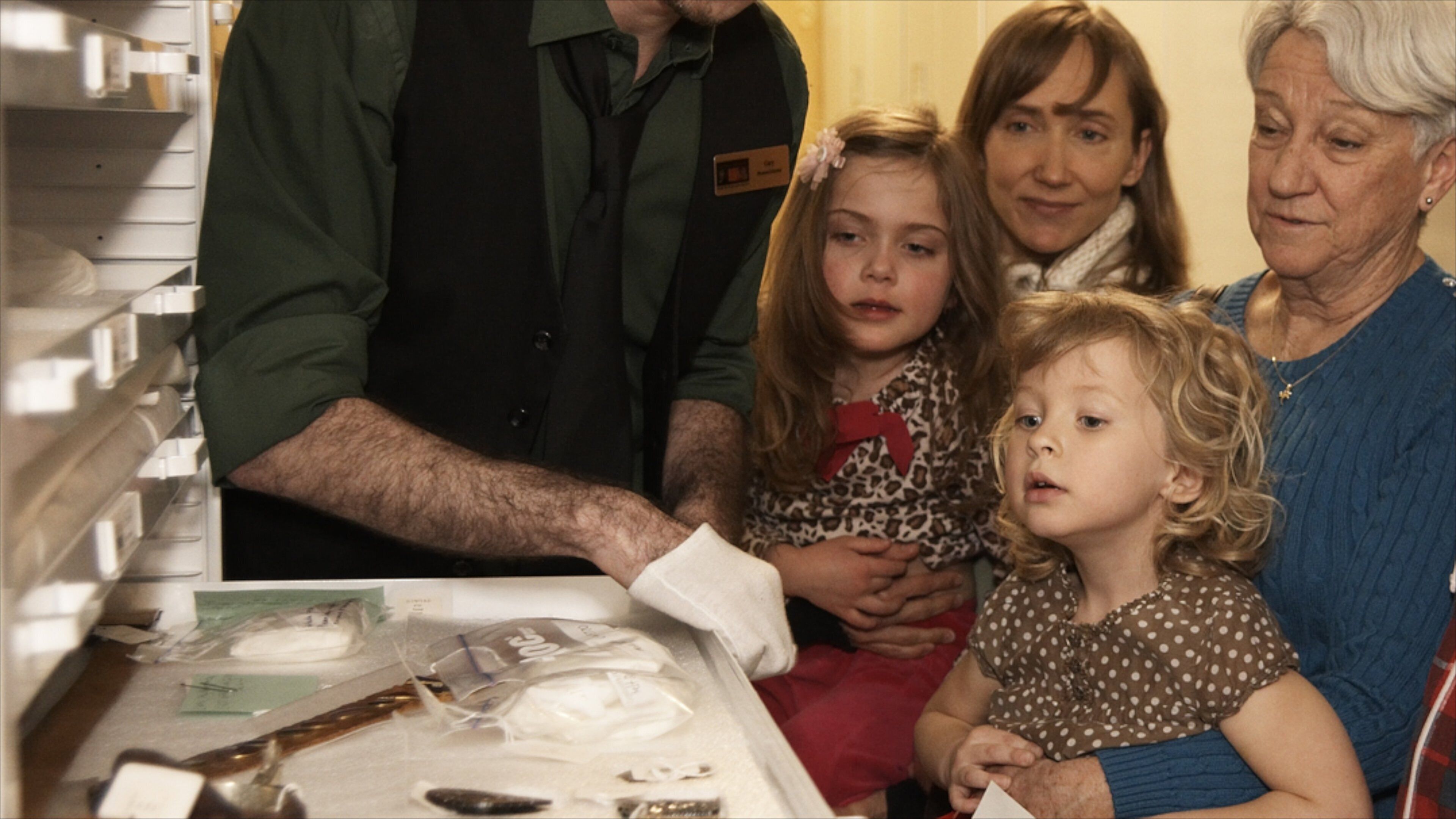 Glenbow Museum featuring interior views as well as a family