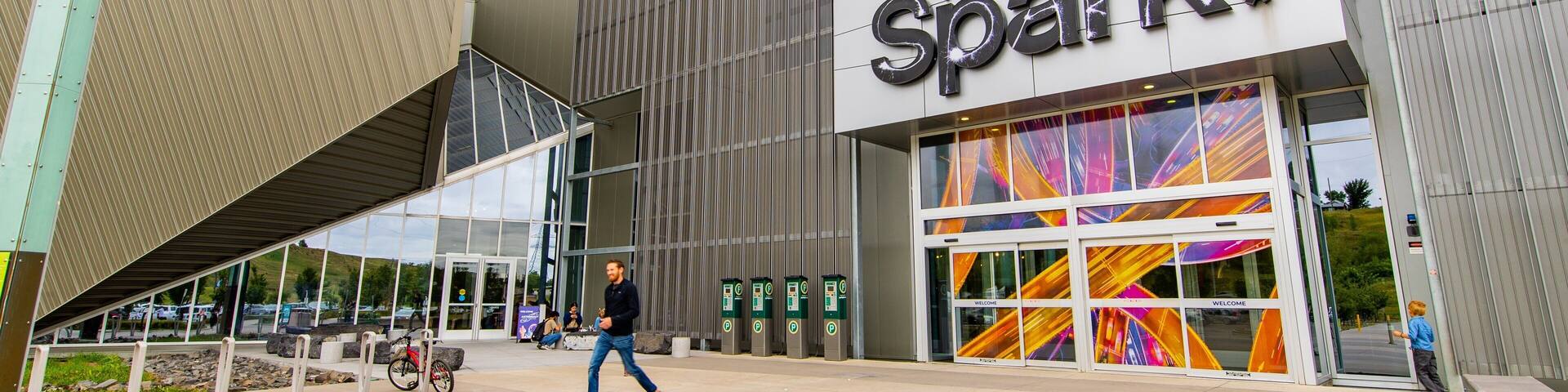 A modern building with a large sign reading "TELUS Spark."