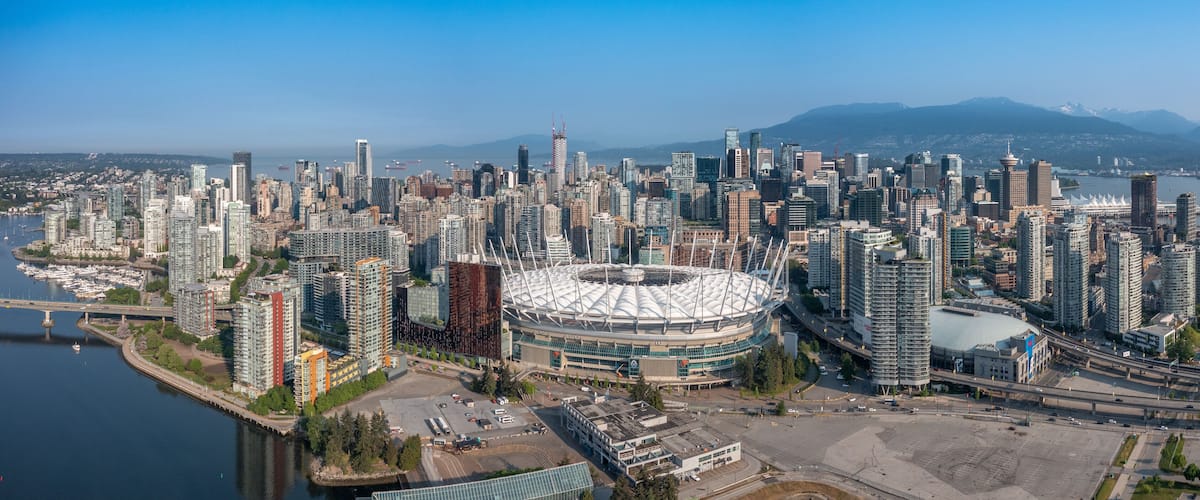 Vancouver, BC, Canada, aerial panoramic city view of famous False Creek in Vancouver downtown with Cambie Bridge and BC Place Stadium in front and Vancouver Skyline in the background