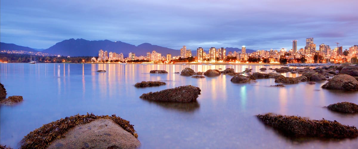 Kitsilano Beach which includes night scenes, a bay or harbor and general coastal views