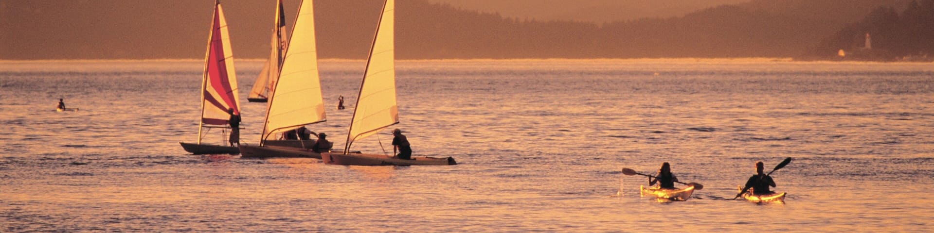 Jericho Beach which includes a sunset, mountains and sailing