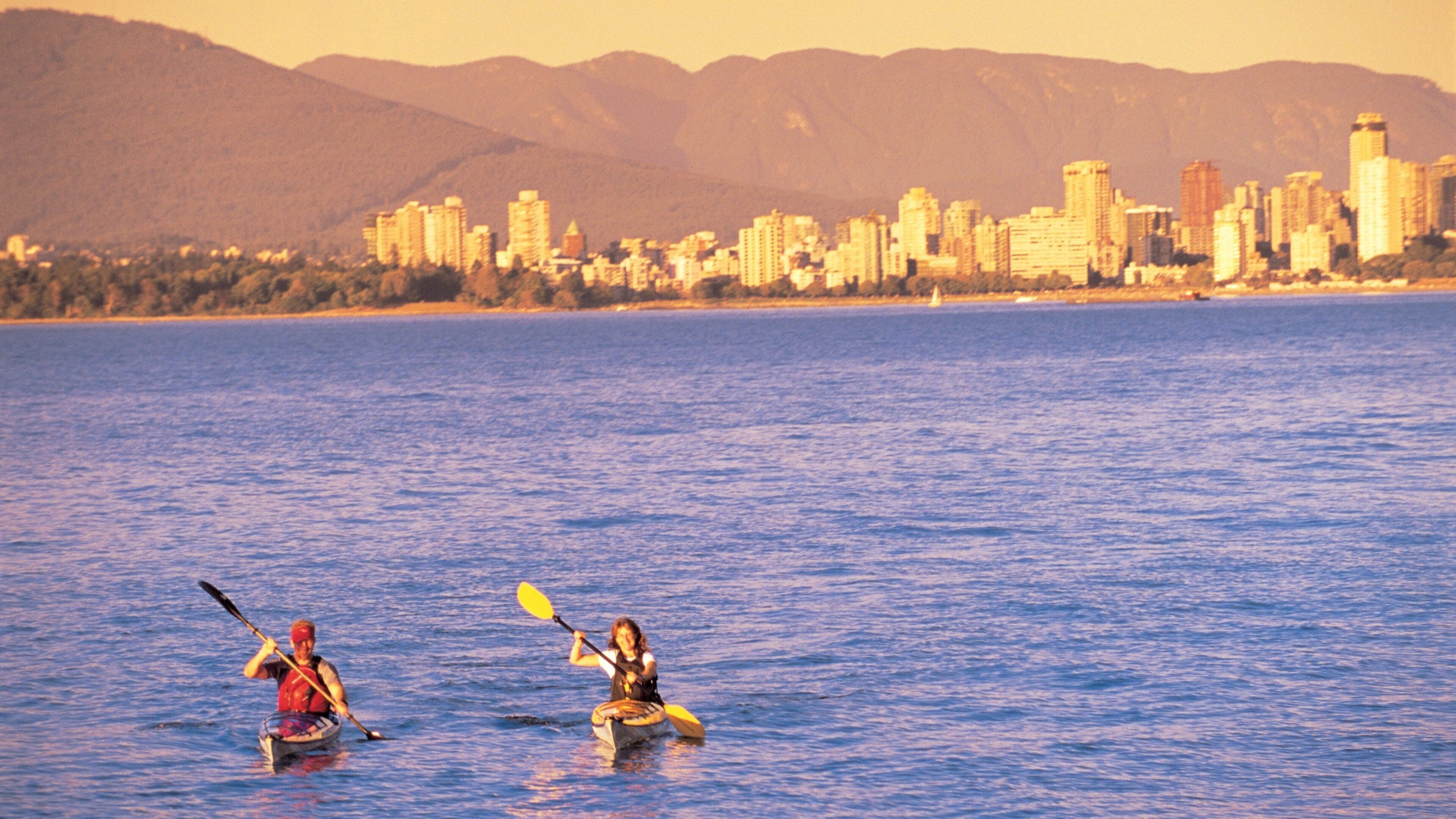 Jericho Beach which includes a sunset, general coastal views and kayaking or canoeing