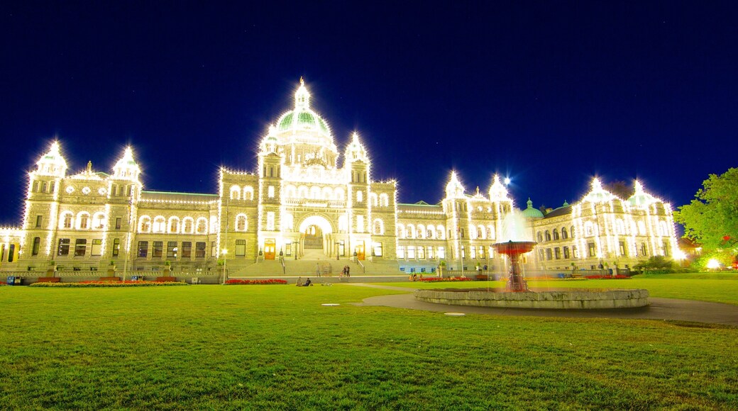 British Columbia Parliament Building featuring heritage architecture, an administrative buidling and night scenes