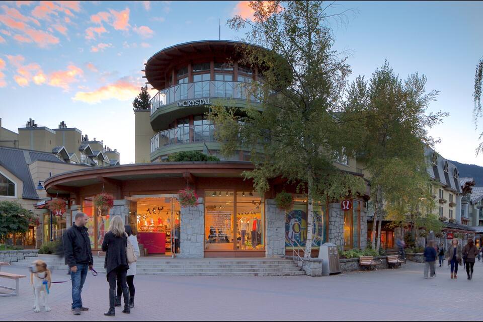 A shopping area with a building named 'The Crystal' and a pedestrian walkway.