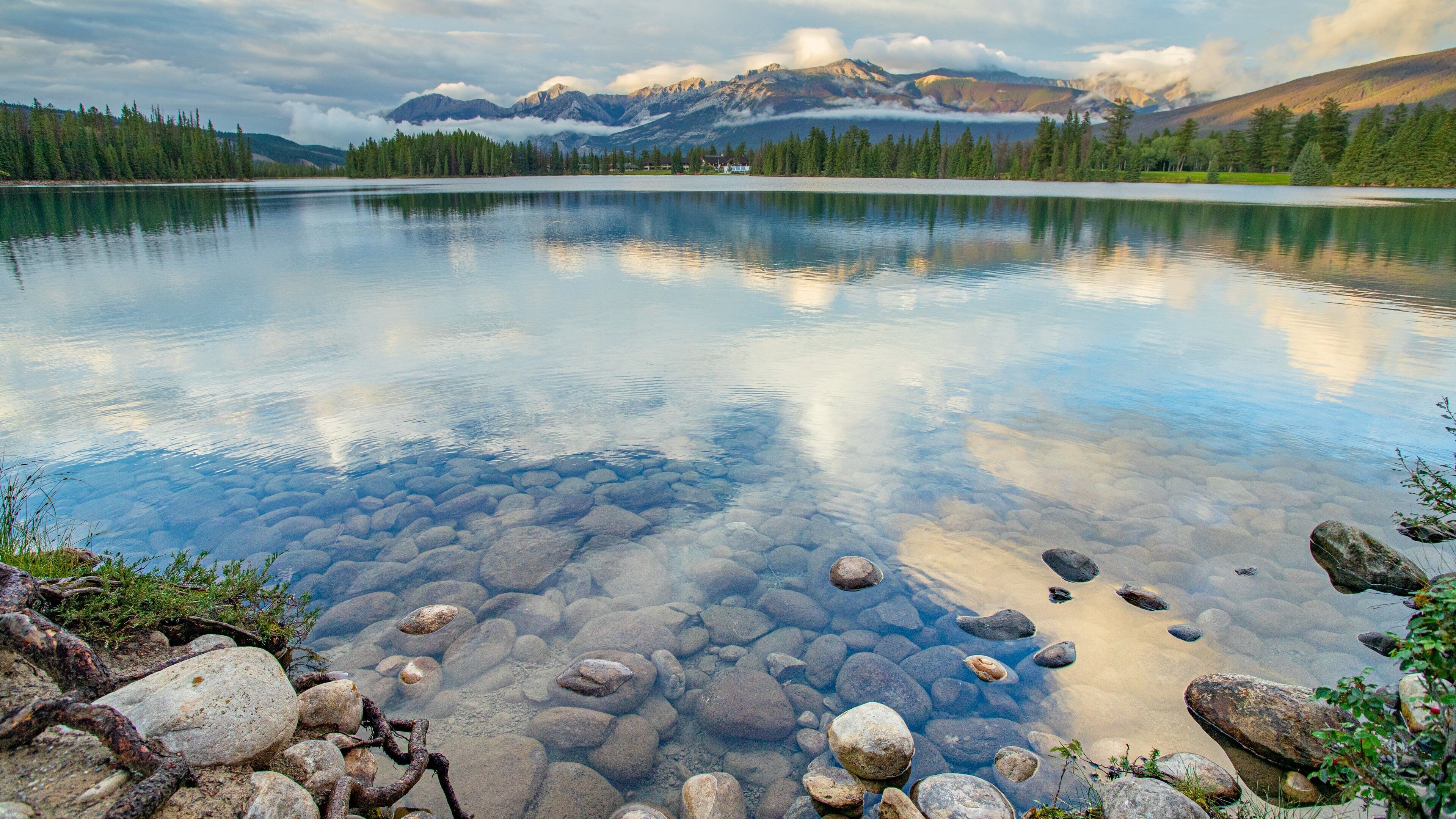 Lac Beauvert featuring a sunset and a lake or waterhole