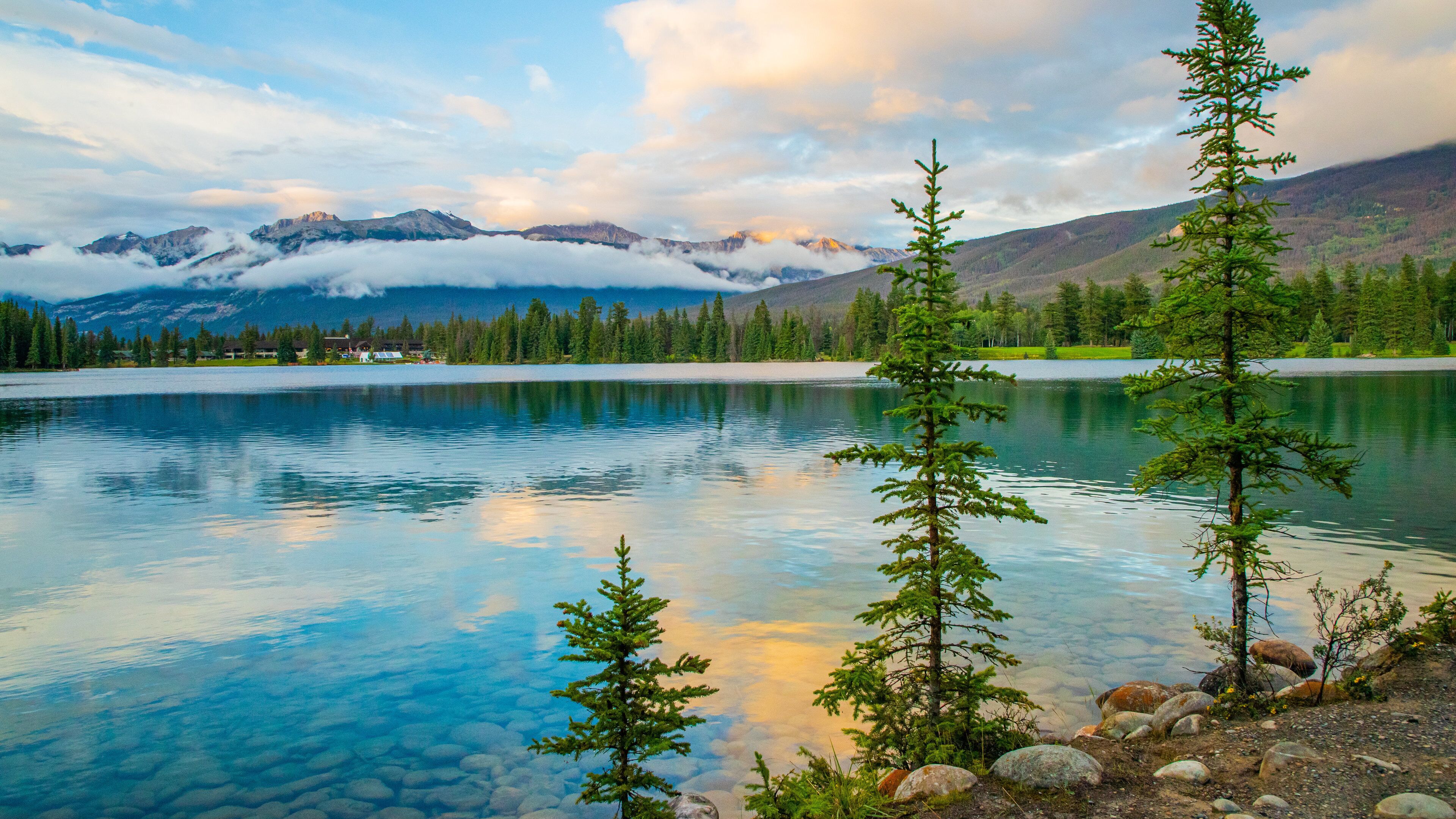 Lac Beauvert which includes a lake or waterhole and a sunset