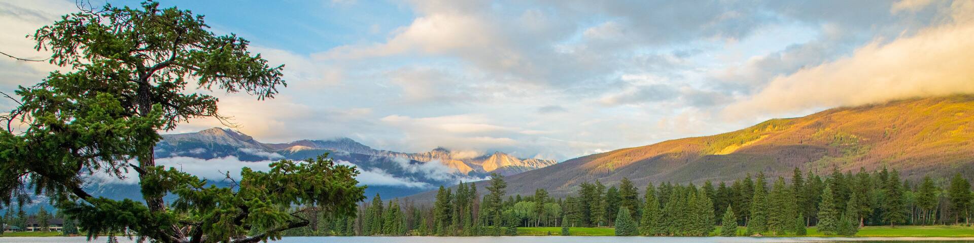 Lac Beauvert featuring a lake or waterhole and a sunset