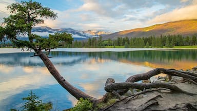 Lac Beauvert featuring a lake or waterhole and a sunset