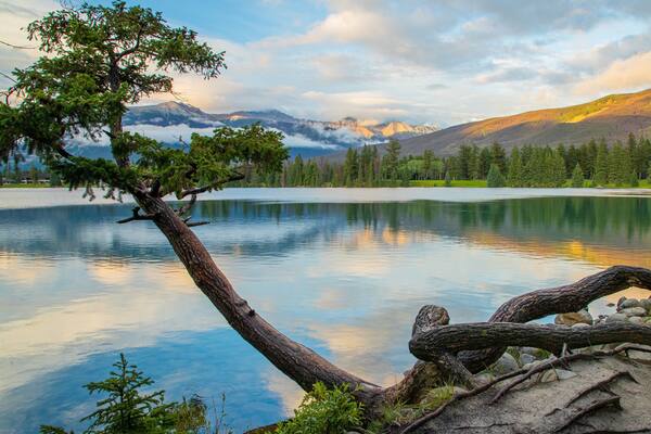 Lac Beauvert featuring a lake or waterhole and a sunset