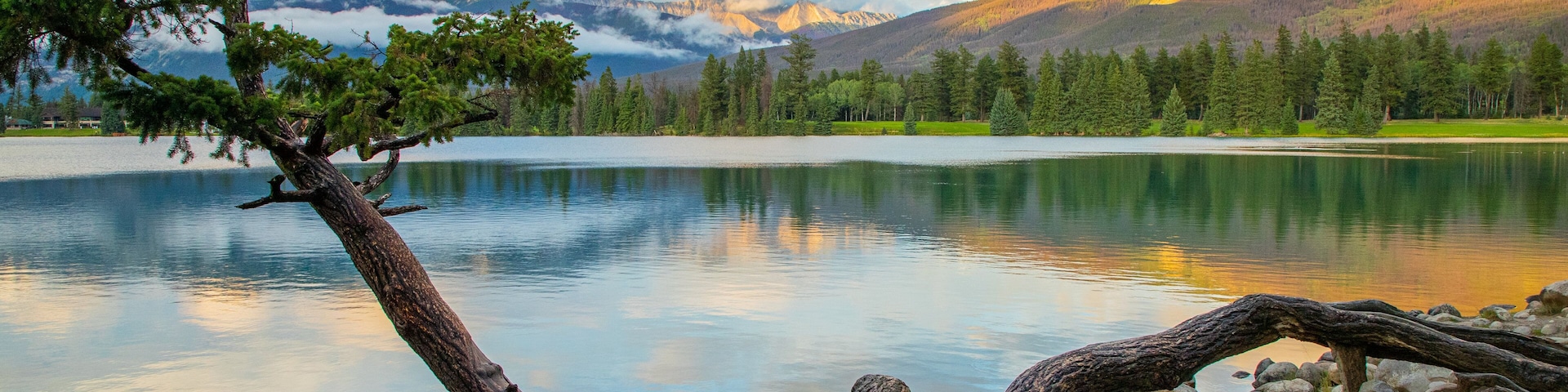 Lac Beauvert featuring a lake or waterhole and a sunset