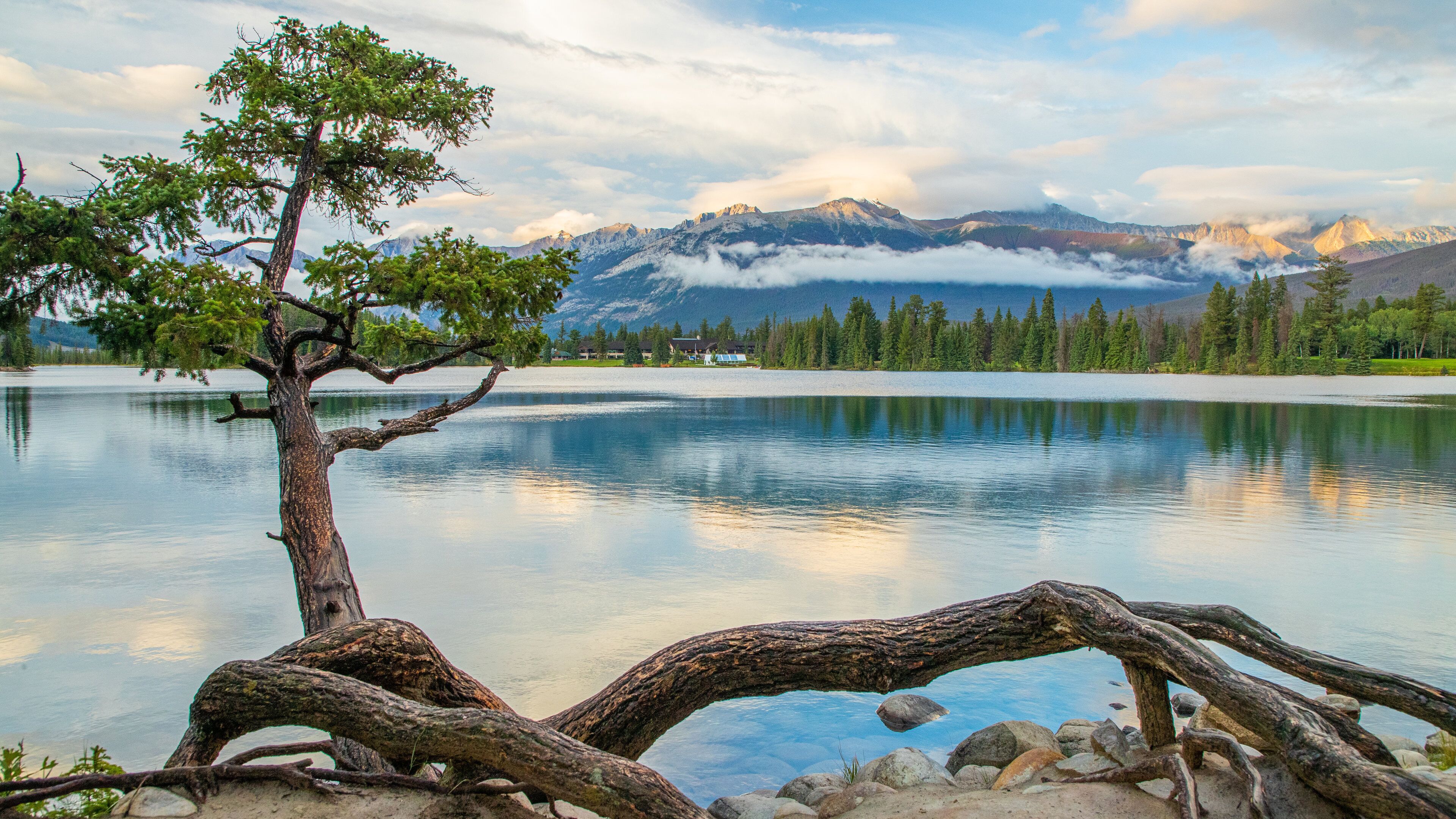 Lac Beauvert which includes a lake or waterhole and a sunset