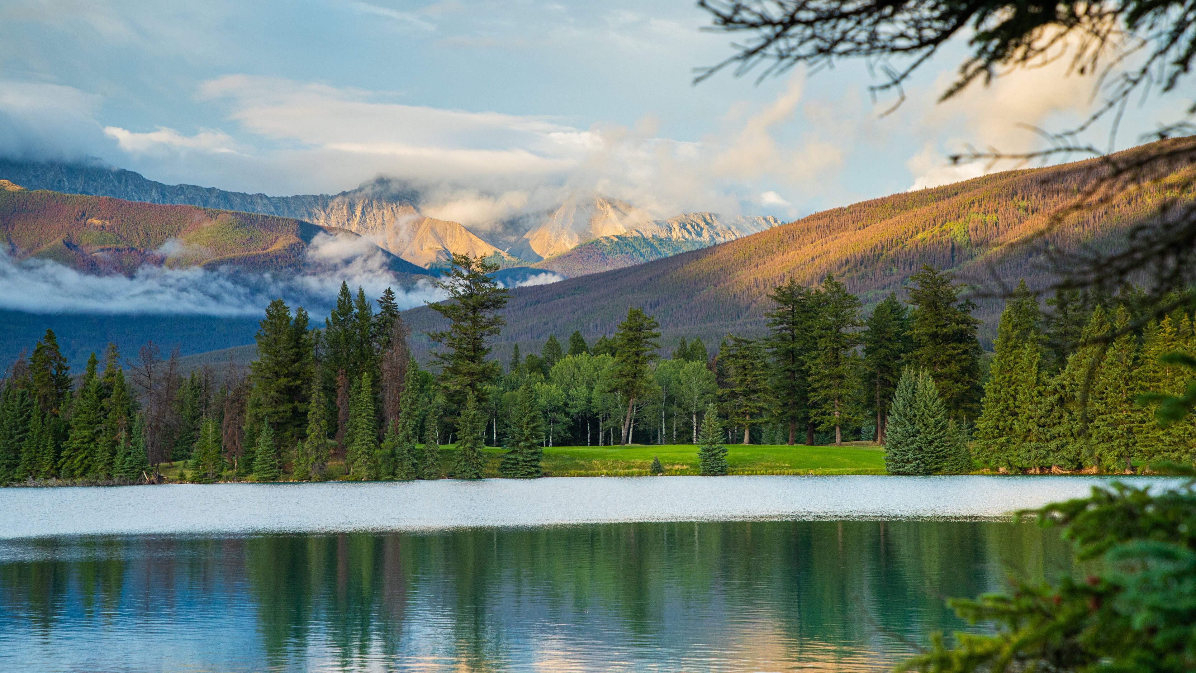 Lac Beauvert featuring a sunset, mist or fog and a lake or waterhole