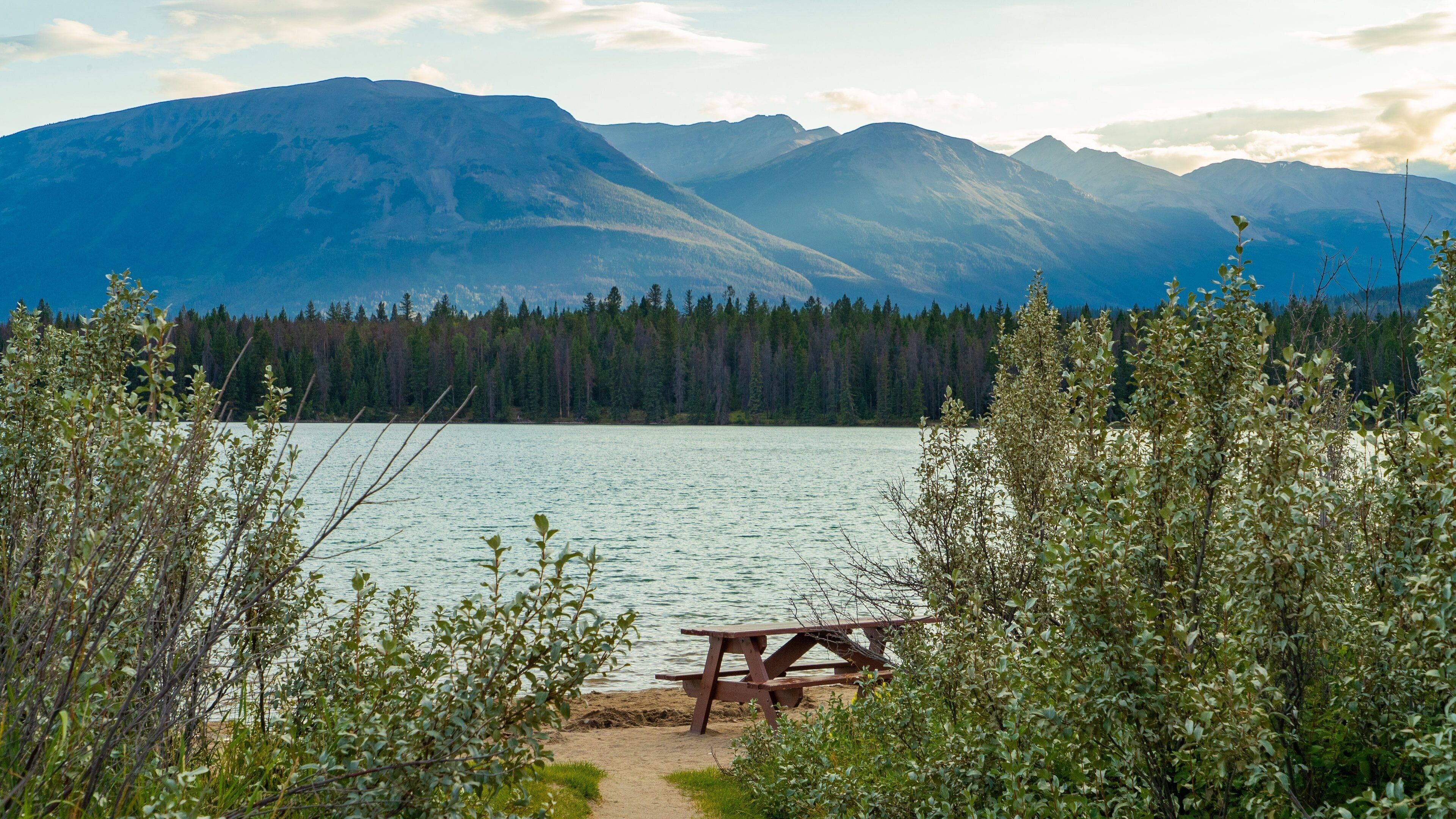 Lake Annette showing a sunset, a lake or waterhole and mountains