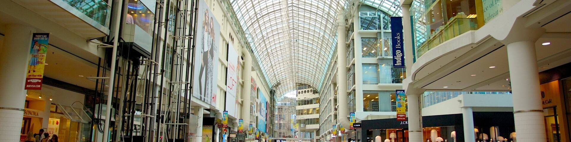 A multi-level shopping mall with a glass ceiling, various stores, and a central atrium.