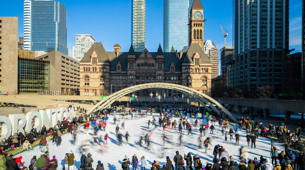 Nathan Phillips Square which includes a city and snow skiing as well as a large group of people