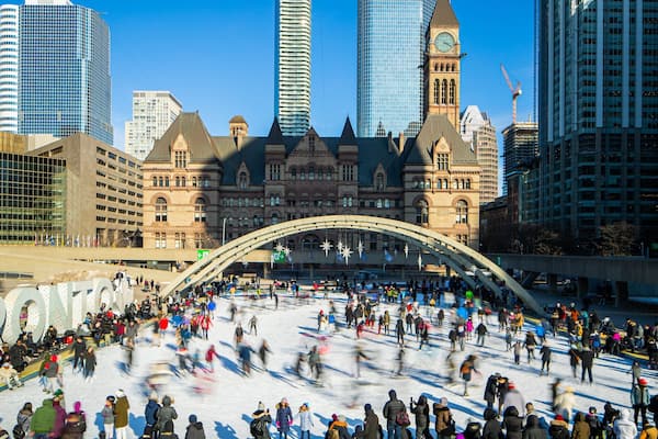 Nathan Phillips Square which includes a city and snow skiing as well as a large group of people