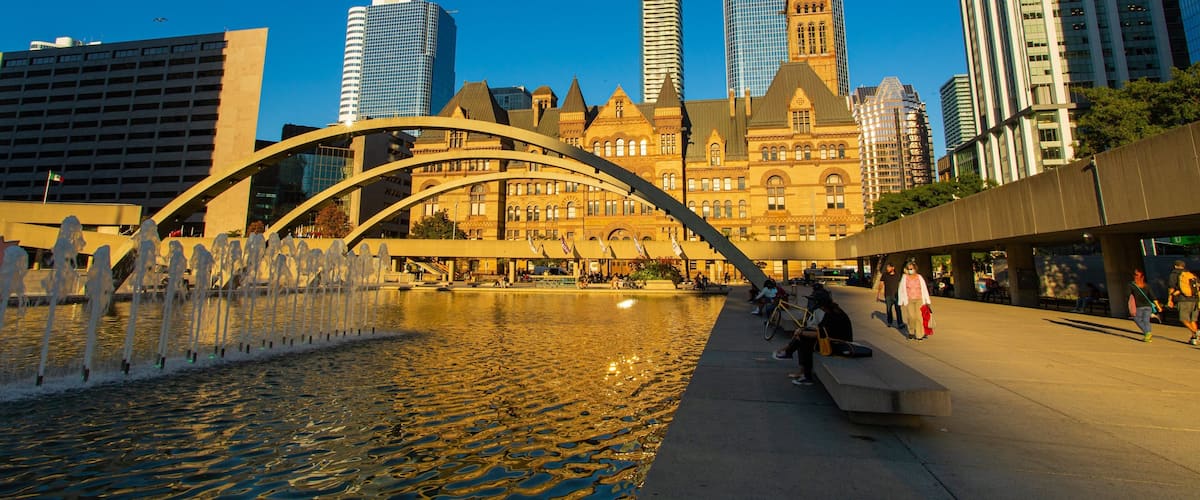 Nathan Phillips Square showing a pond, a city and a fountain