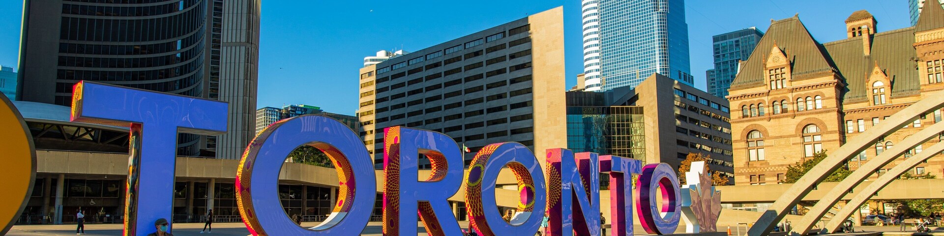 Nathan Phillips Square showing a pond, signage and a city