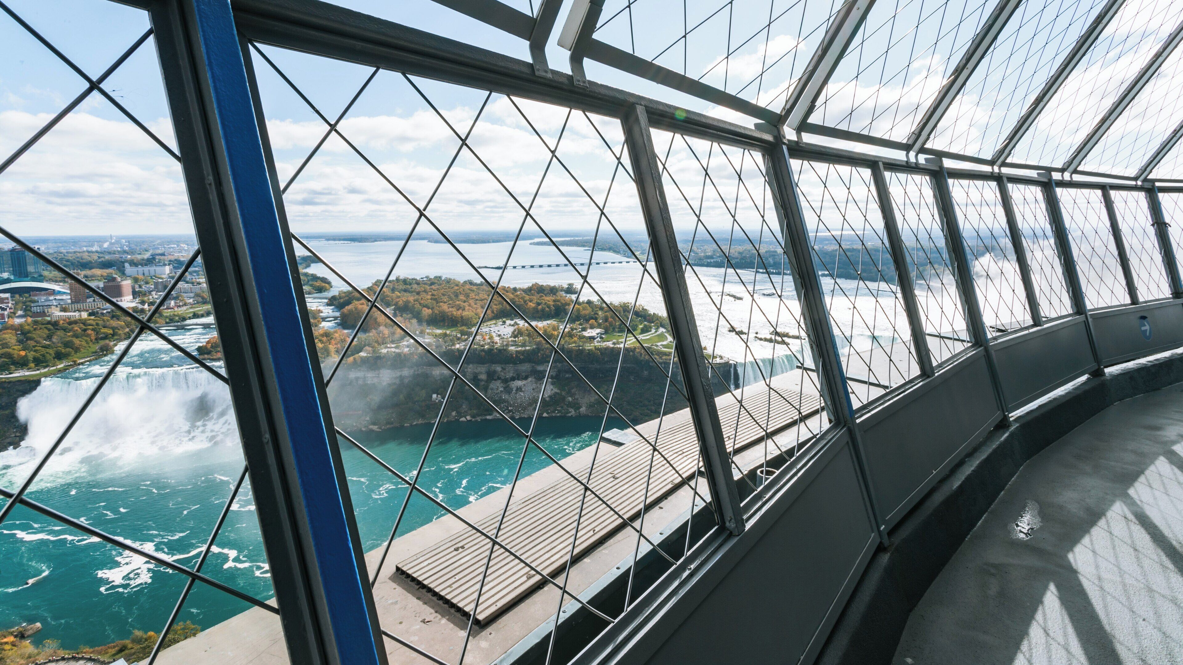 View from Skylon Tower overlooking Niagara Falls, showcasing the stunning water cascades and the lush landscape in Ontario, Canada