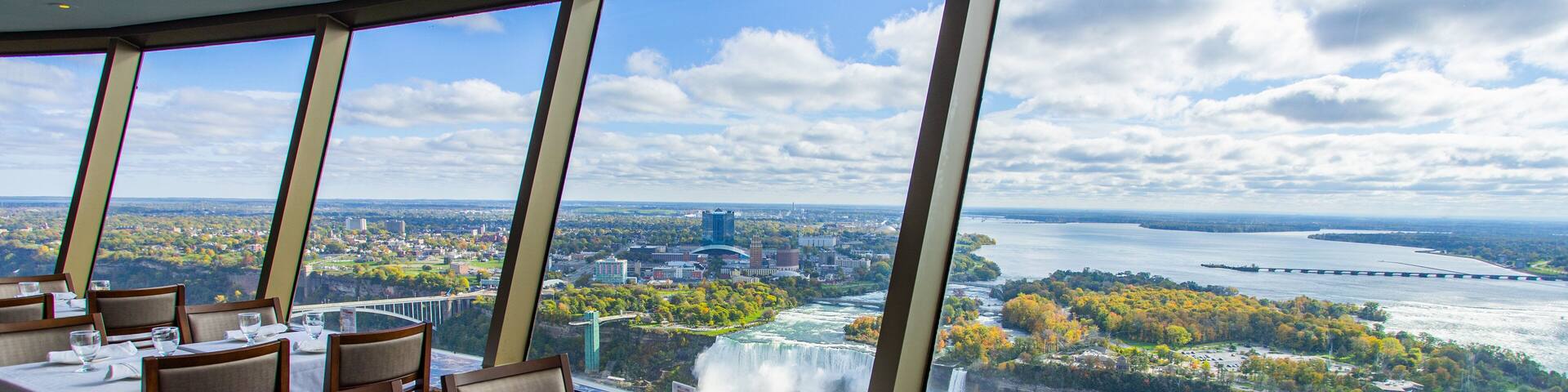 A restaurant with a view of a waterfall and a river.
