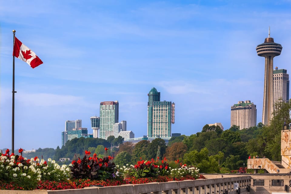 A cityscape with a prominent tower and a flag.