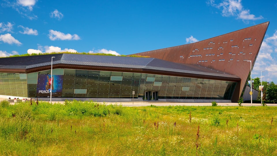 A modern building with a unique triangular roof and large glass windows.