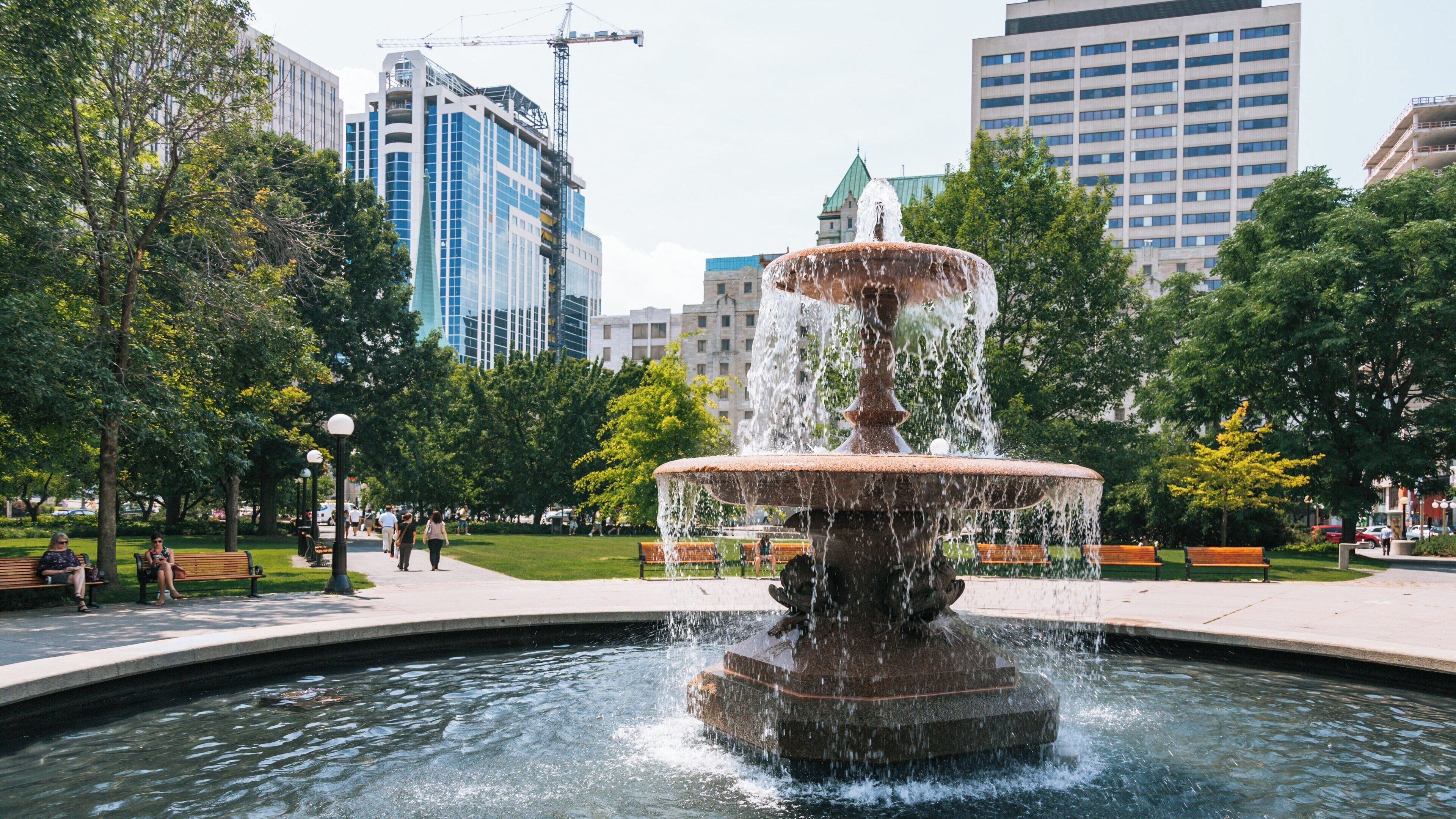 Fountain in the vibrant Glebe area overlooking Rideau Canal in Ottawa, Ontario, reflects the bustling city life and natural beauty