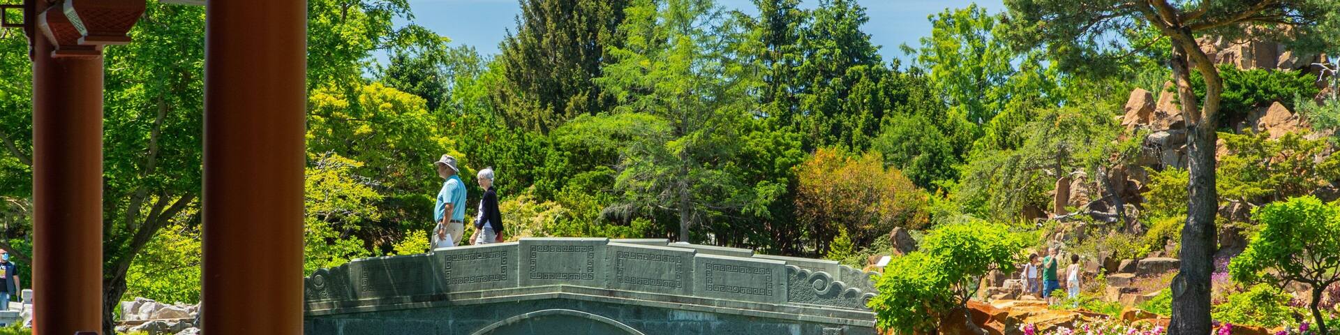 Montreal Botanical Garden showing a park, a river or creek and a bridge