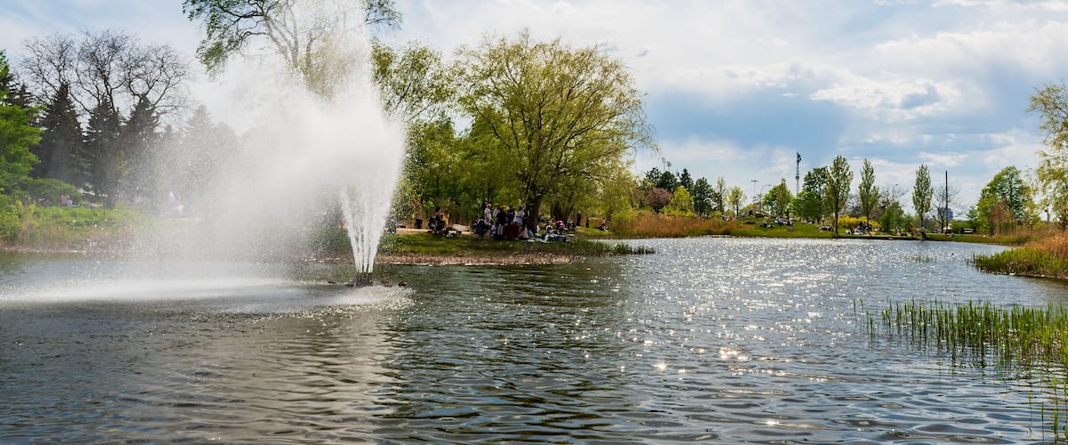 View of a Jarry park pond and fountain in Montreal, Canada