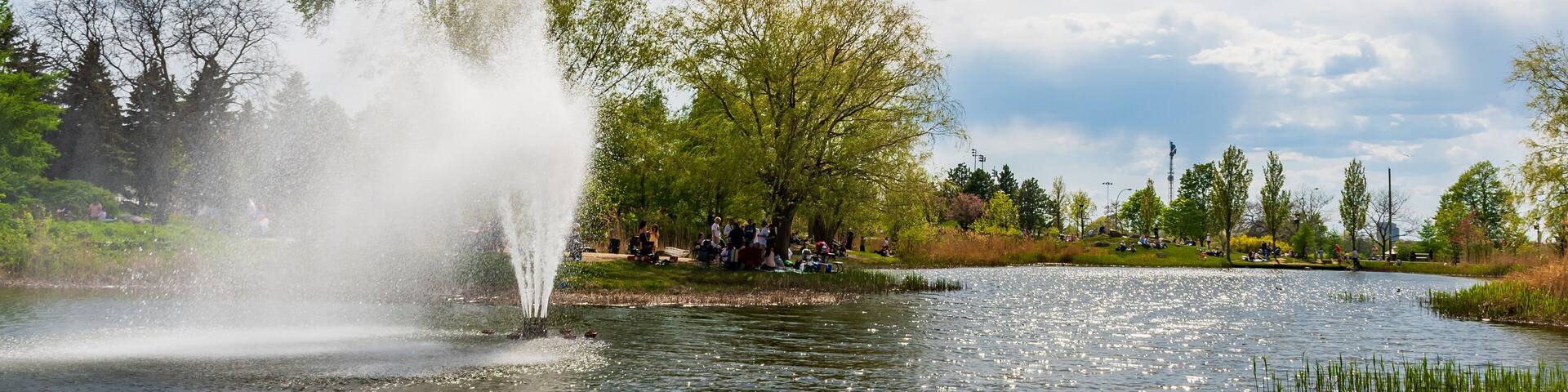 View of a Jarry park pond and fountain in Montreal, Canada