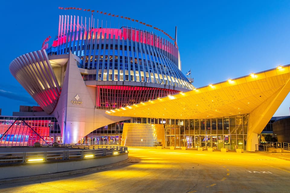 A modern building with a unique curved design and a large entrance canopy.