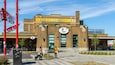 A brick building with a sign reading "MARCHÉ JEAN-TALON" and a "PREMIERE MOISSON" sign.
