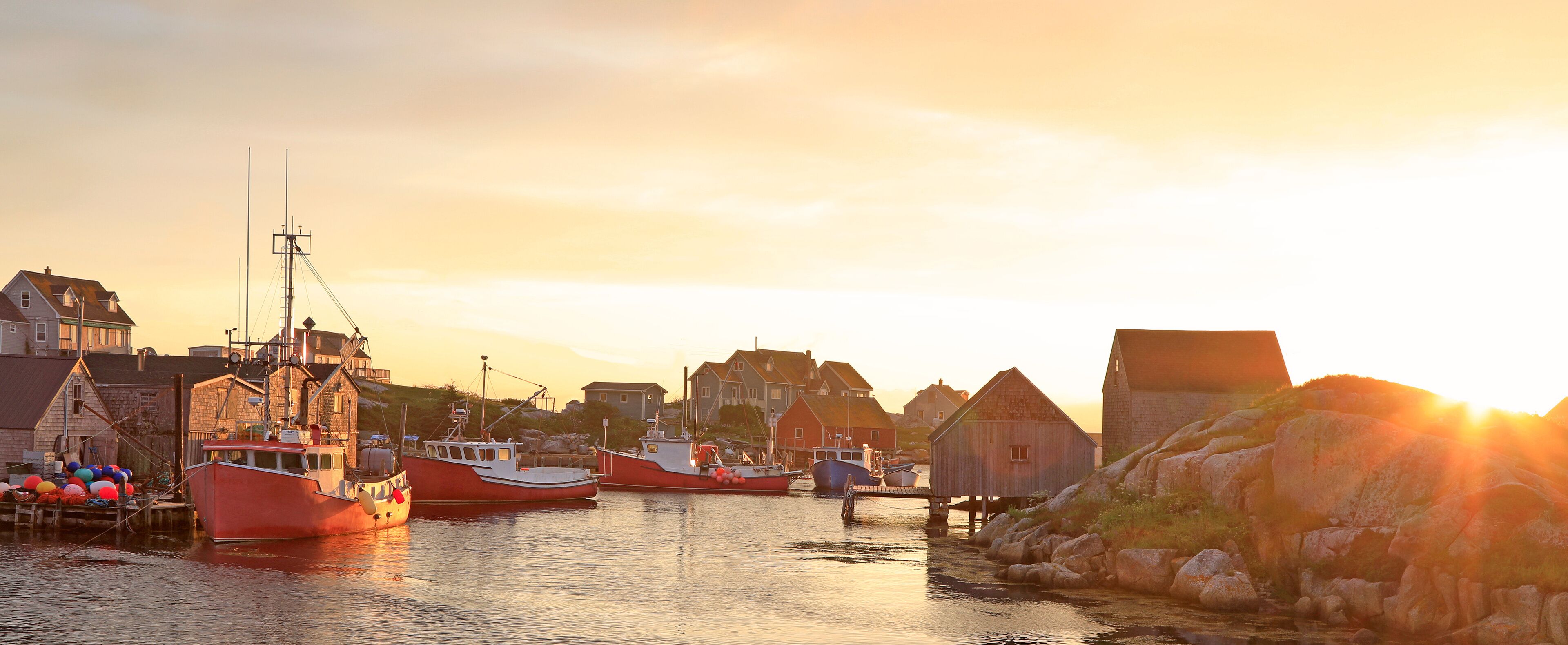 Peggy’s Cove Lighthouse and village illuminated at dusk, Nova Scotia, Canada

