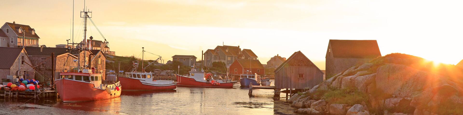 Peggy’s Cove Lighthouse and village illuminated at dusk, Nova Scotia, Canada