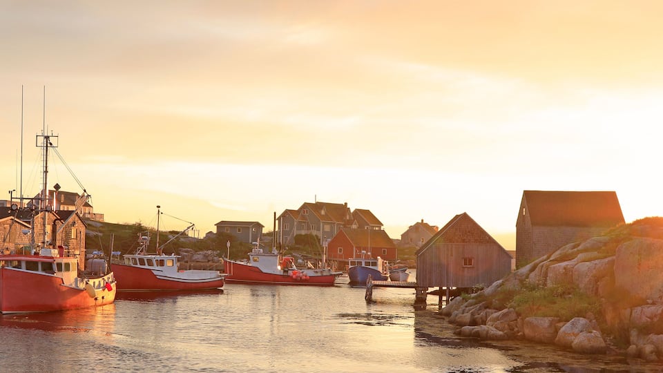 Peggy’s Cove Lighthouse and village illuminated at dusk, Nova Scotia, Canada
