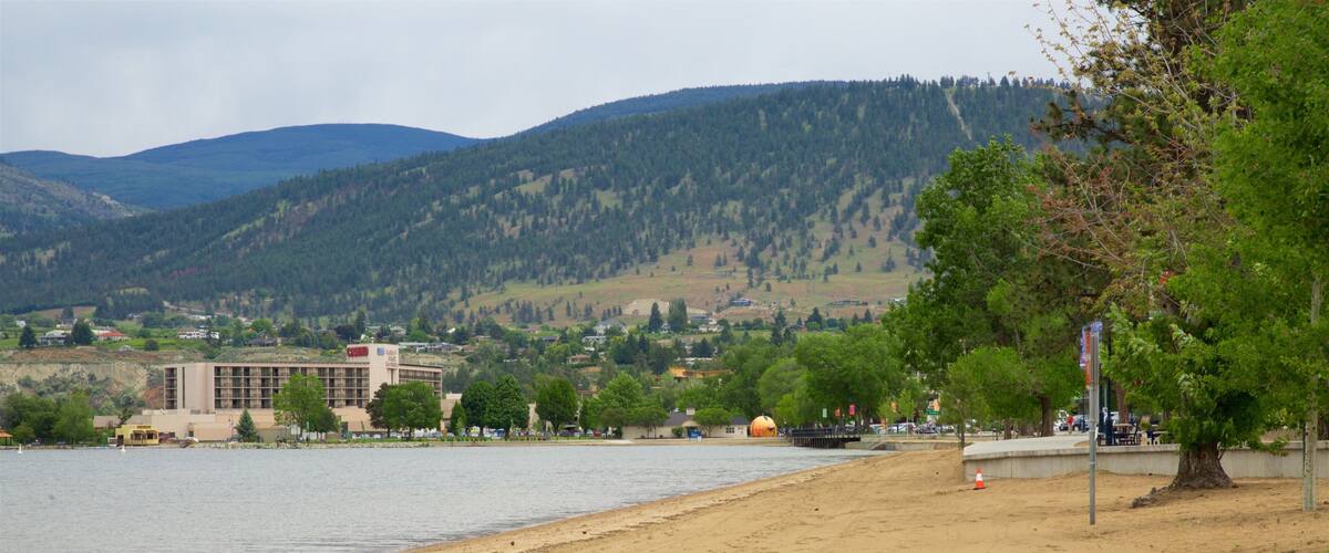 A sandy beach with a building labeled "Adelphi" and a forested hill in the background.