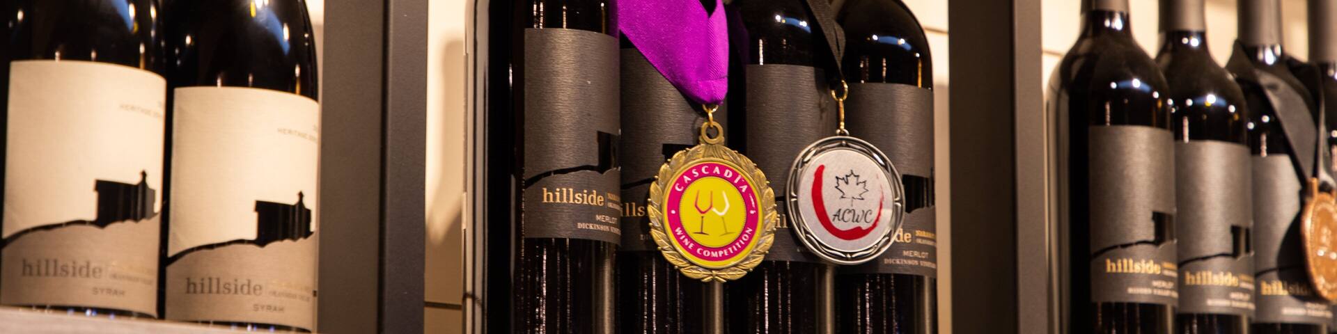 A display of wine bottles with medals on them.