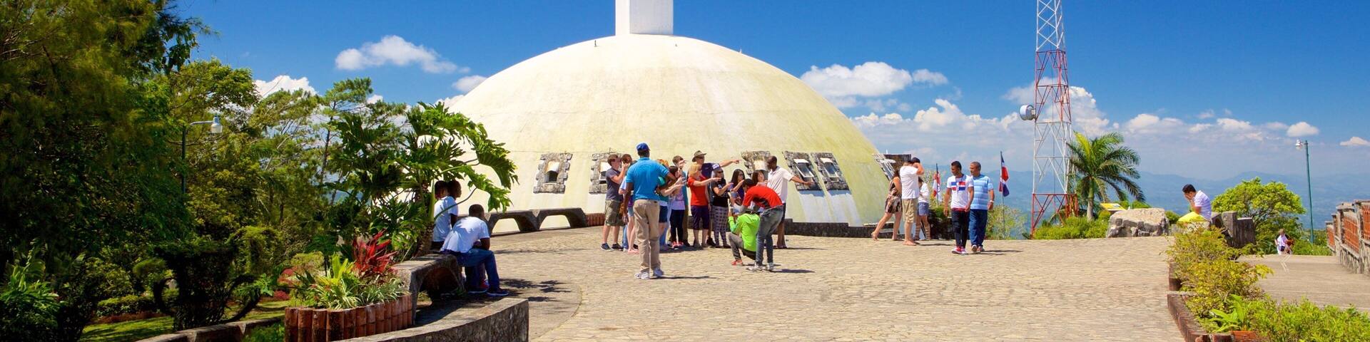 Pico Isabel de Torres featuring religious elements and a statue or sculpture as well as a small group of people