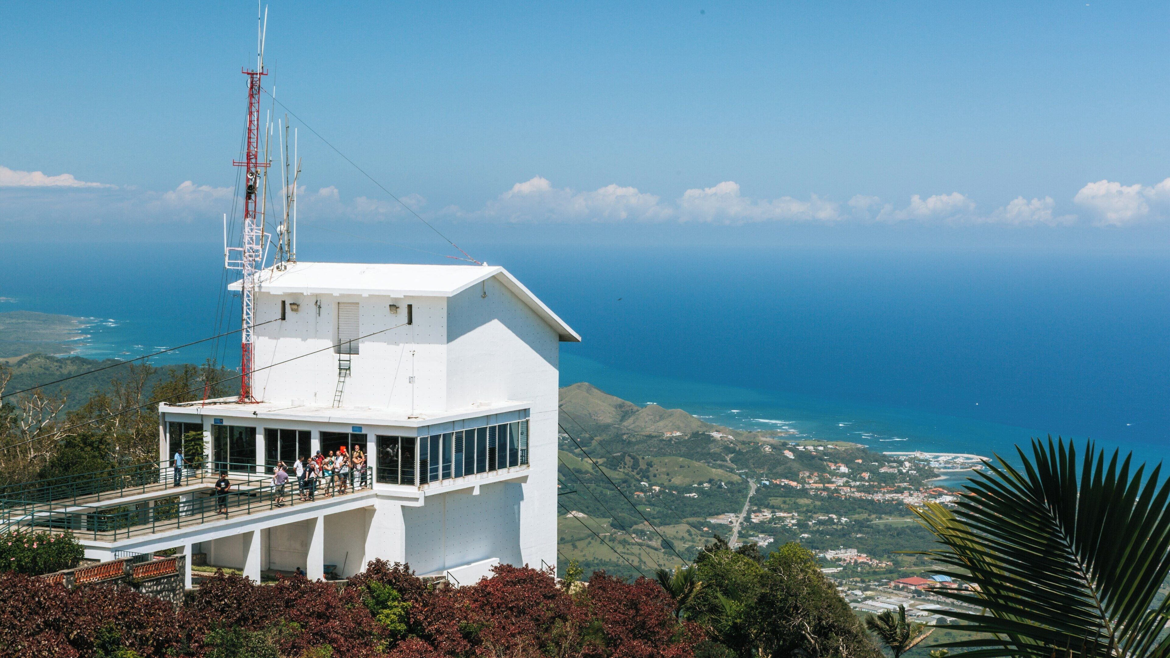 Stunning view from Pico Isabel de Torres overlooking Puerto Plata, with vibrant vegetation and clear blue skies in the Dominican Republic