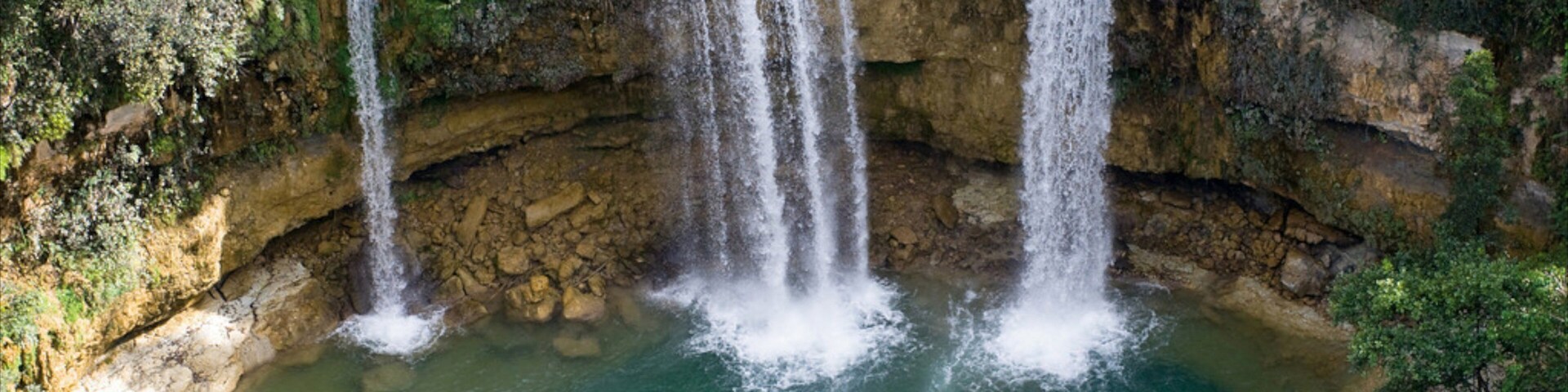 Los Haitises National Park featuring a waterfall and a lake or waterhole