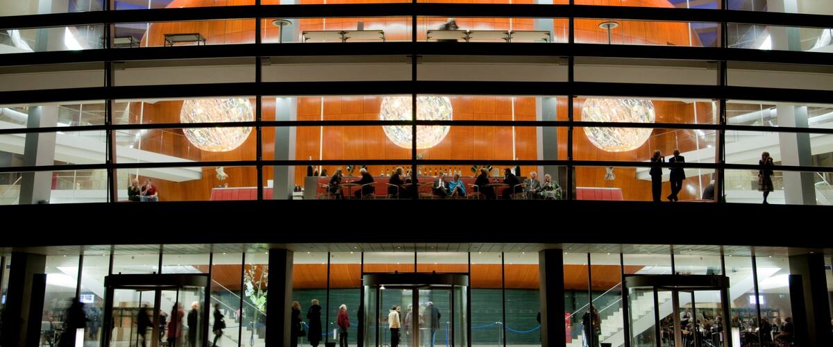 Copenhagen Opera House which includes night scenes, modern architecture and theater scenes