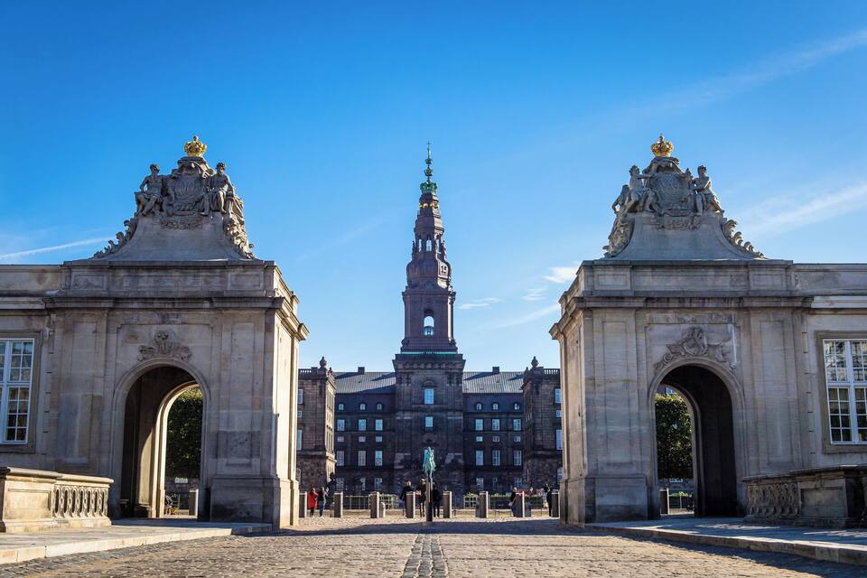 A historic building with two ornate arches and a central tower.