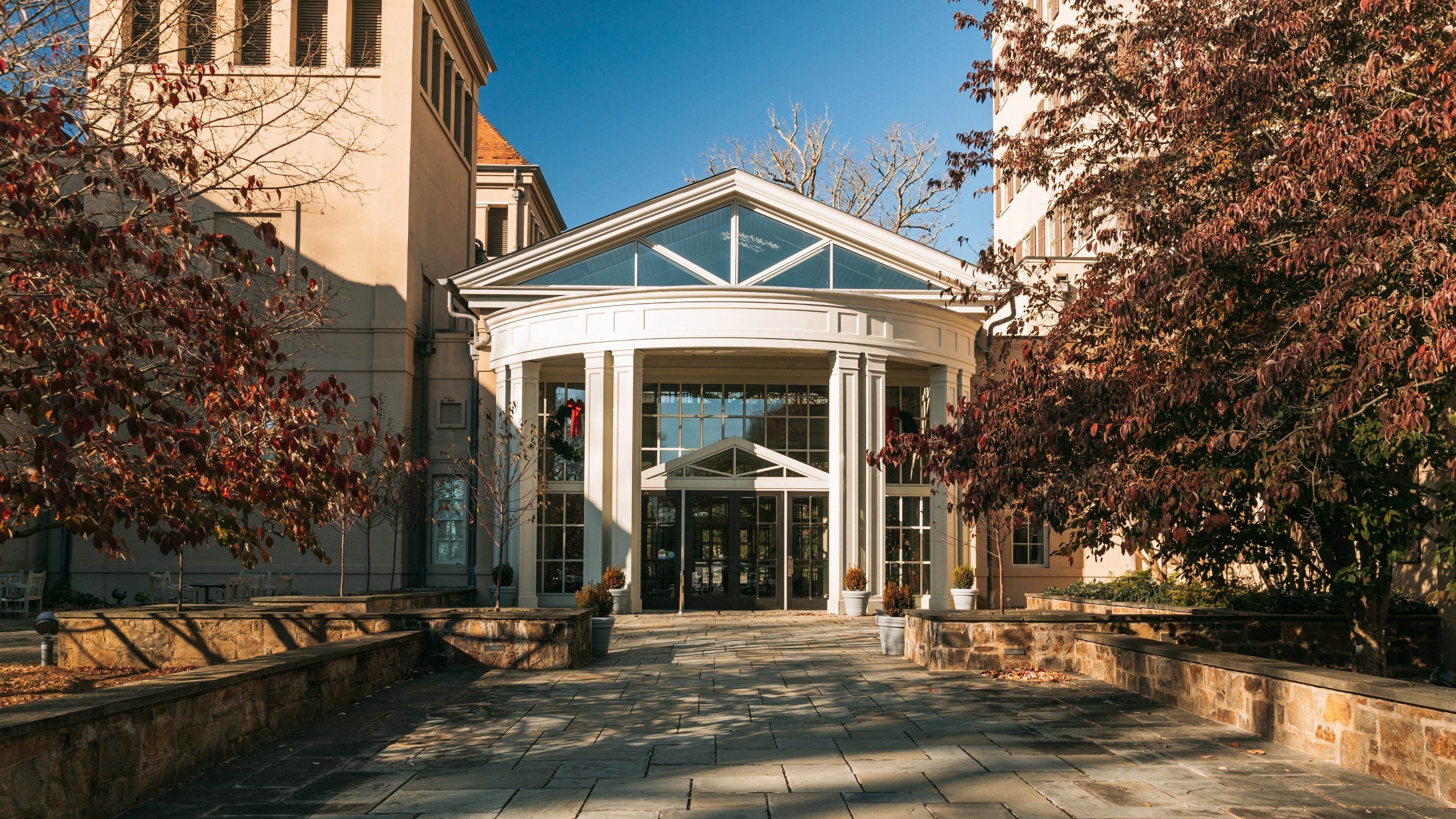 A building with a glass entrance and a white roof.