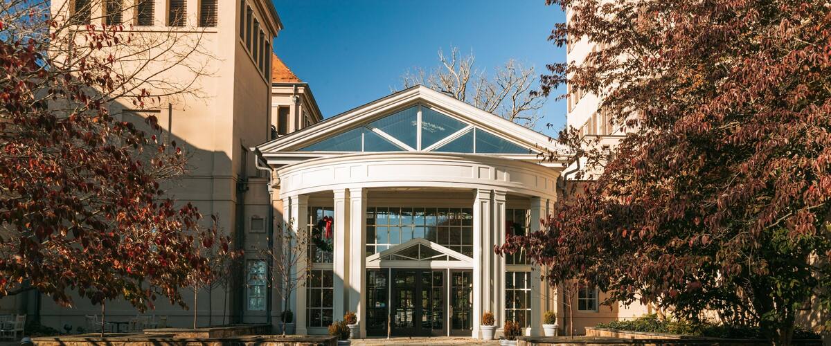 A building with a glass entrance and a white roof.