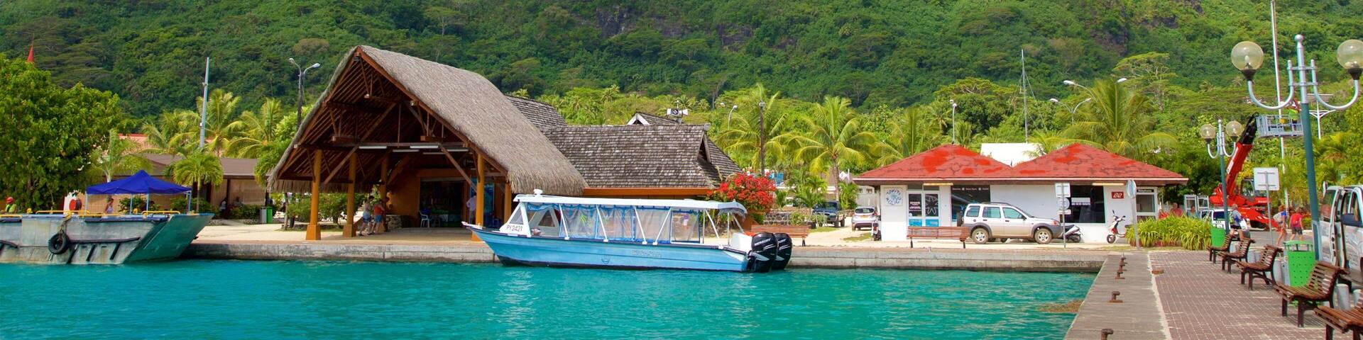 Vaitape Harbor which includes general coastal views, mountains and tropical scenes