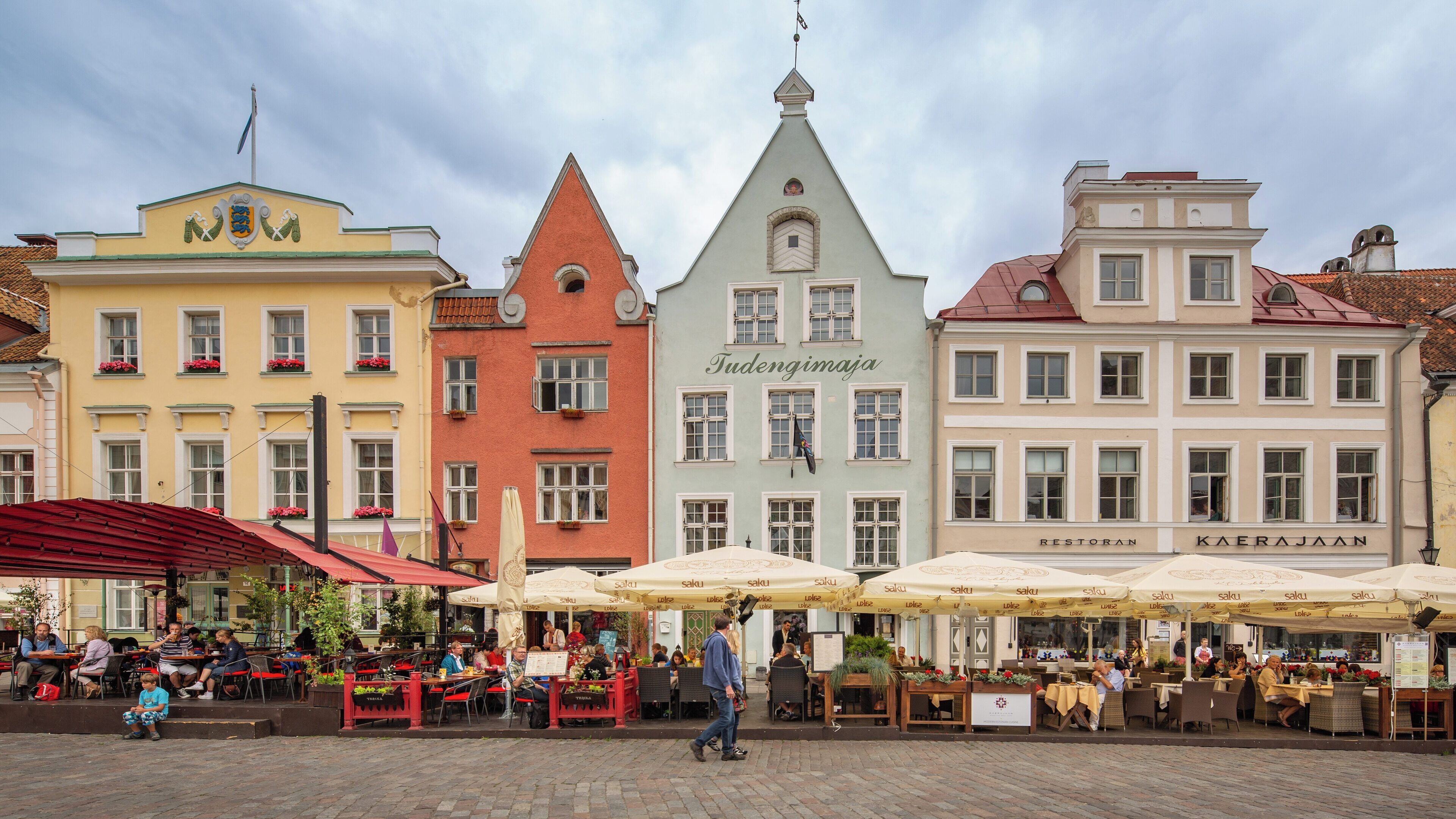 Historic architecture and vibrant outdoor cafes create a lively atmosphere in Town Hall Square, Old Town Tallinn in Harju County, Estonia