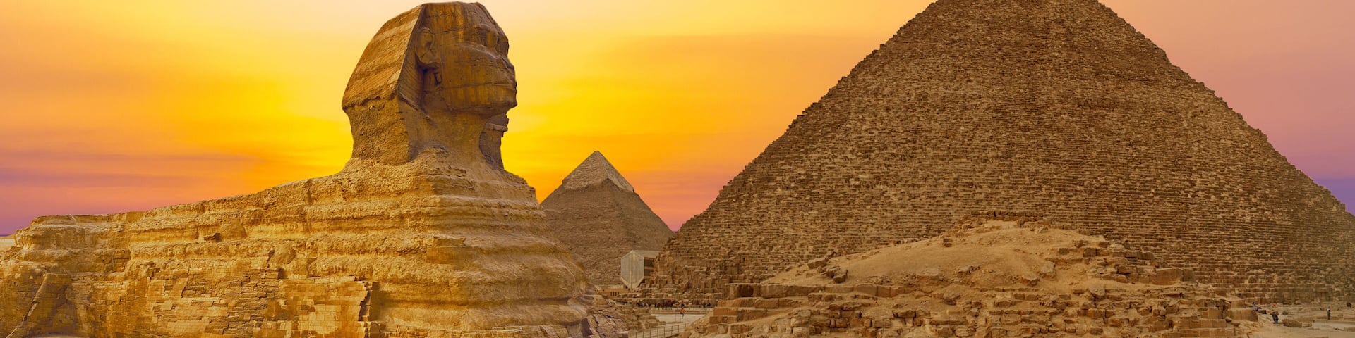 Sphinx against the backdrop of the great Egyptian pyramids. Africa, Giza Plateau.