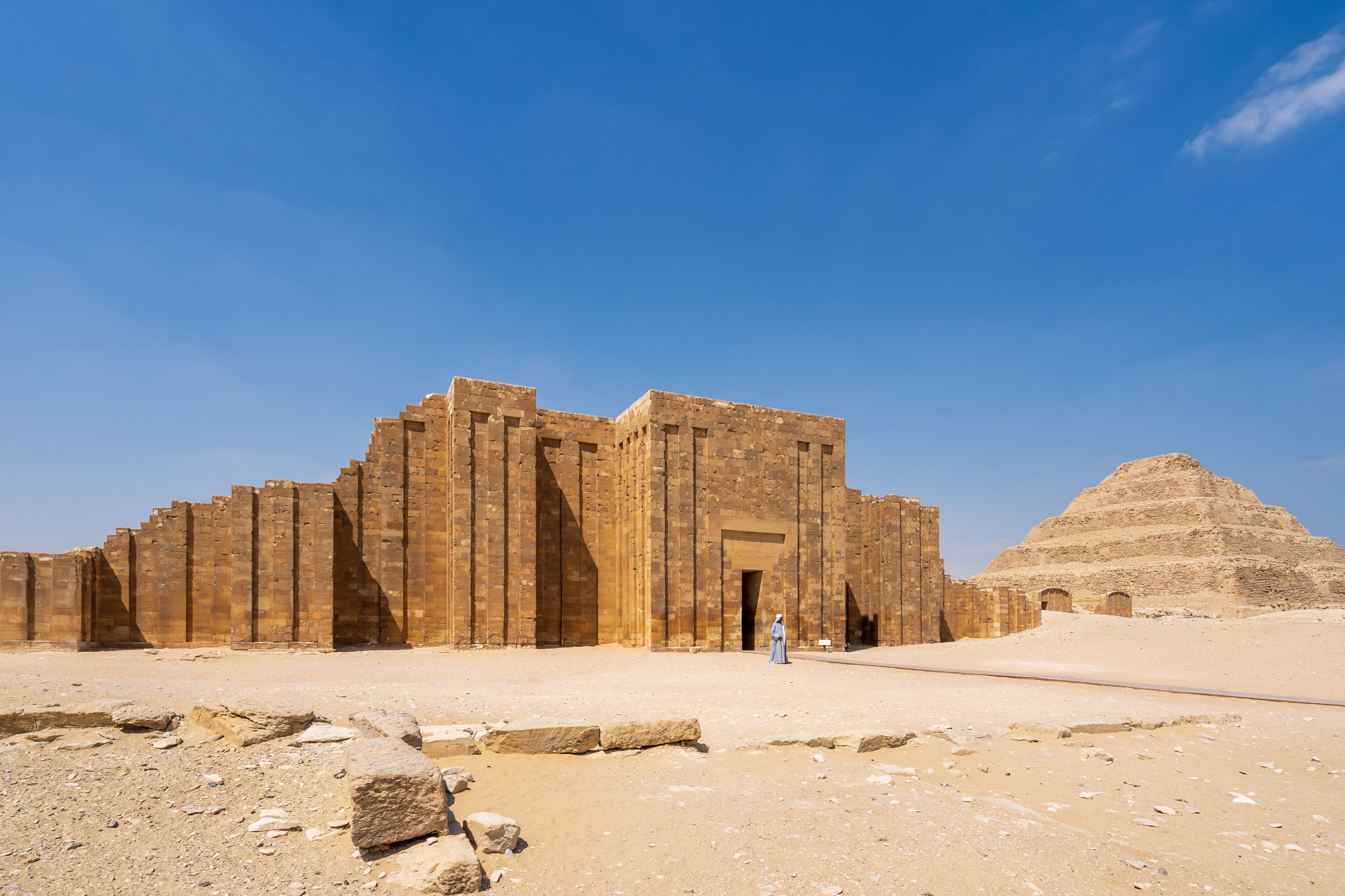 A large ancient Egyptian temple complex with a pyramid in the background.